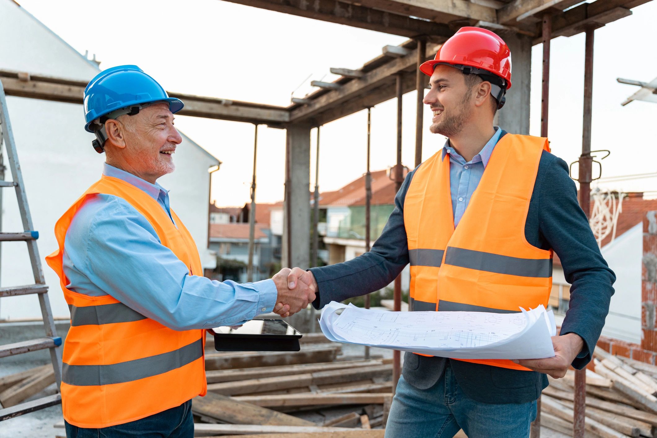 Engineer shaking hands with an architect at a construction site