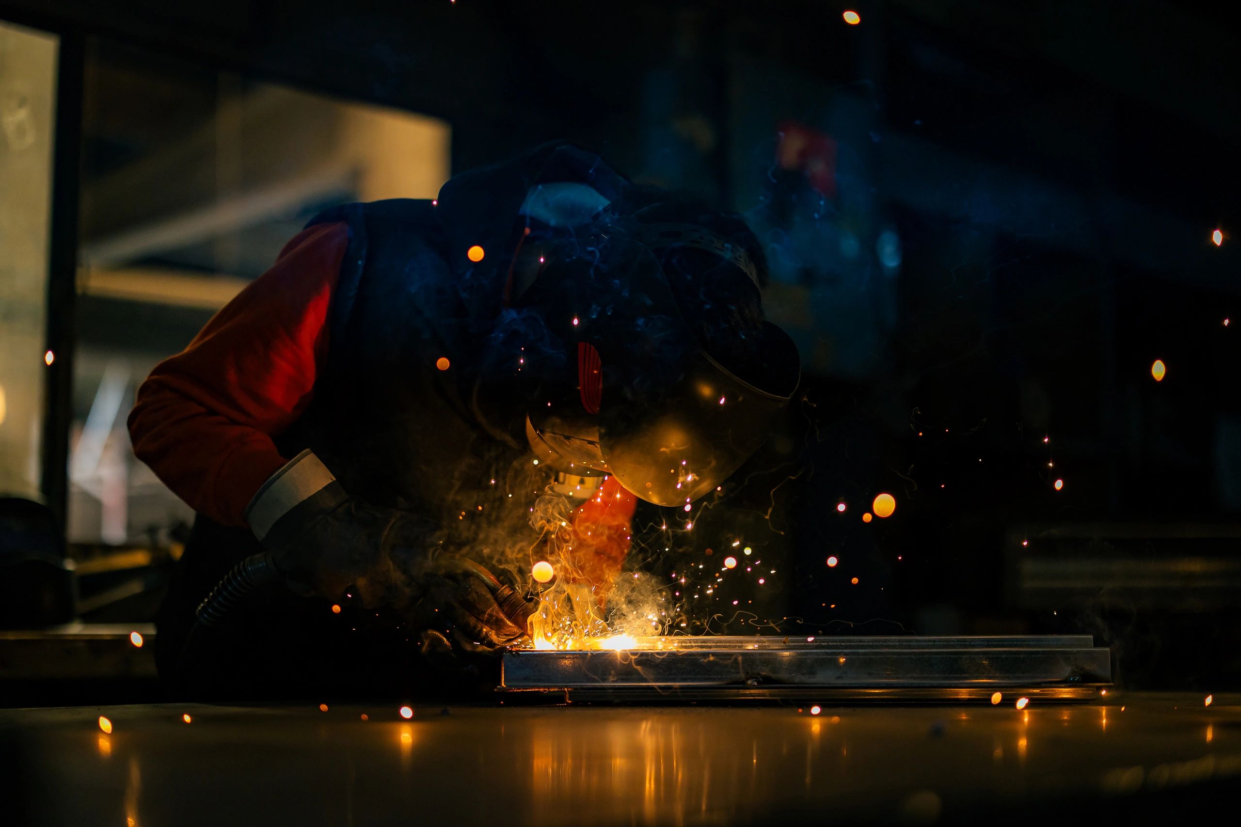 Industrial steel welder working in a factory